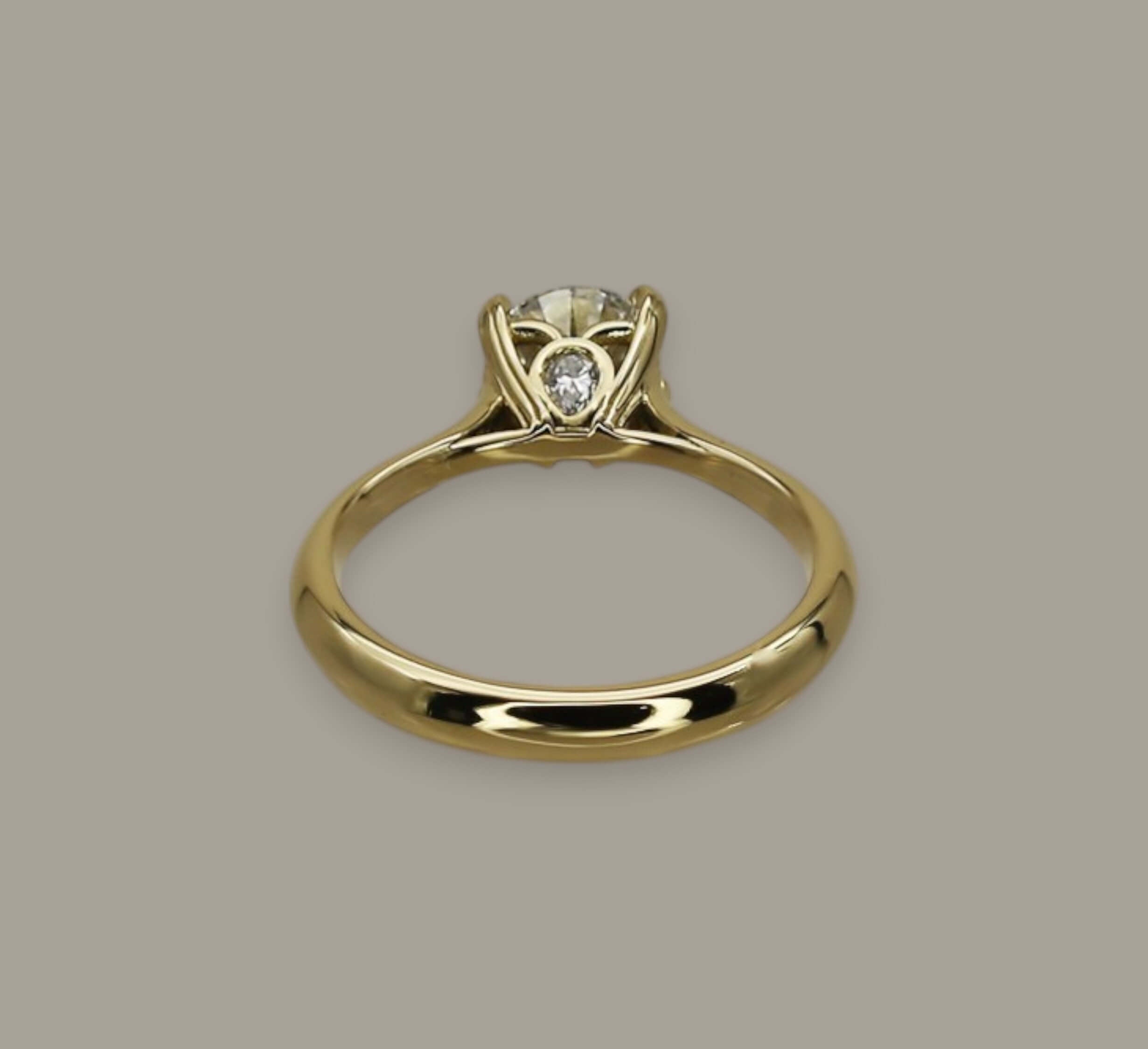 0.72ct Round Brilliant Cut Diamond Solitaire Engagement Ring in 18ct Yellow Gold with Pear Diamond Detail - Neil Rayment Goldsmiths