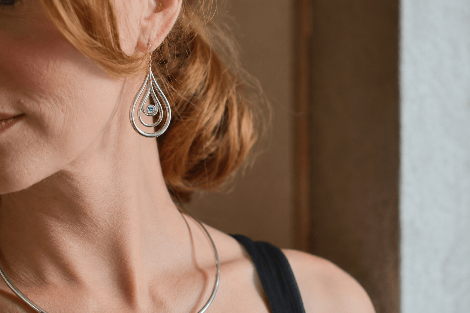 Carreg Las medium sterling silver blue diamond drop earrings worn on ear
