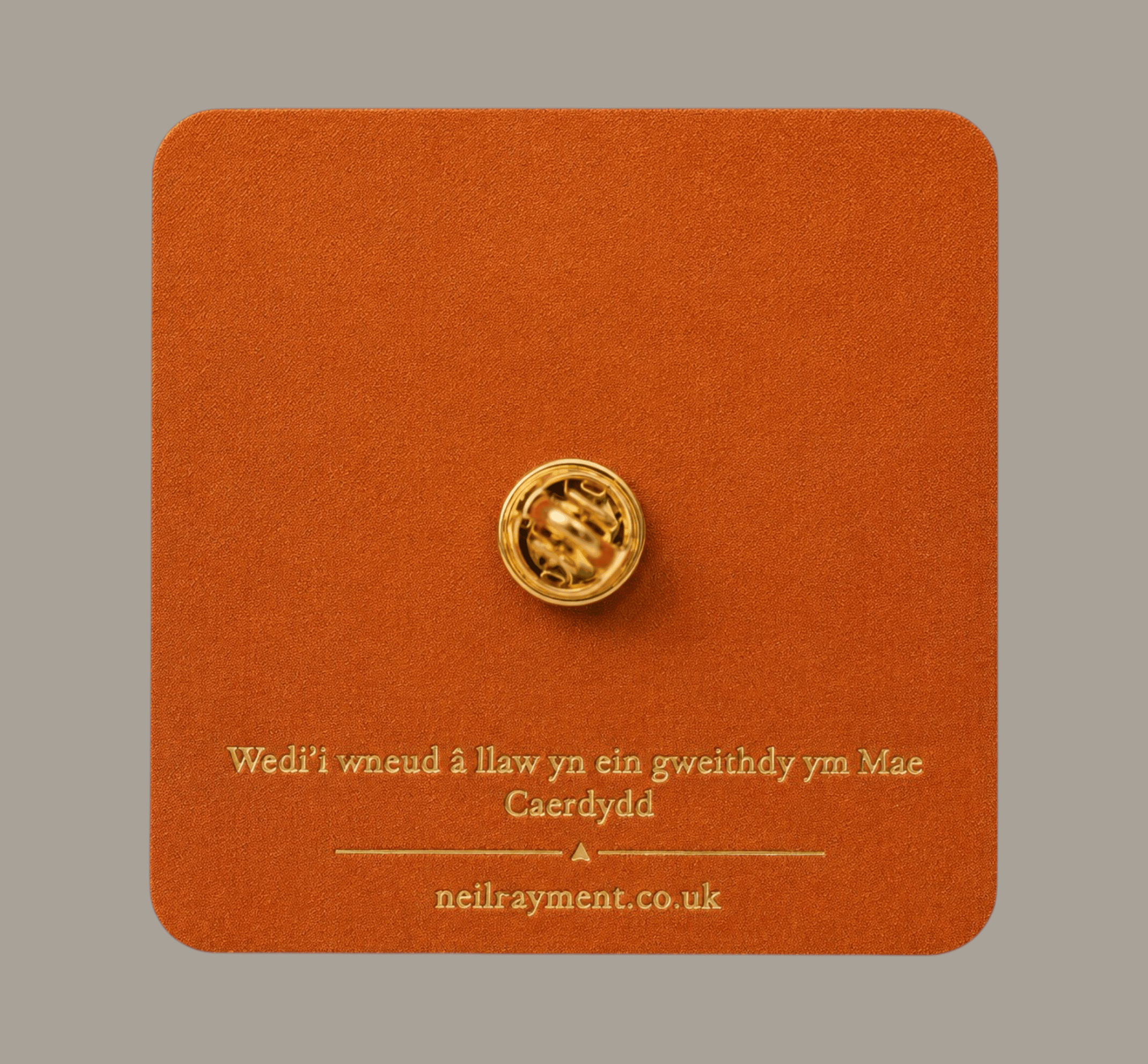 Back of Eisteddfod 850 lapel pin on branded Welsh packaging